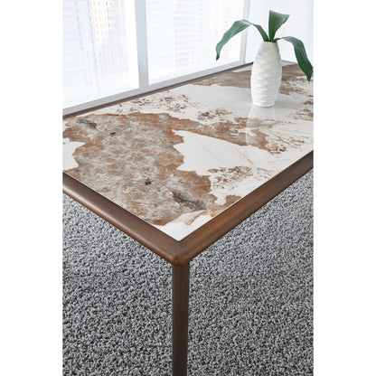 Tavolo da pranzo con piano in pietra Tulum e base in metallo bronzo